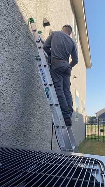Dryer Vent Cleaning Austin technician at work on a home