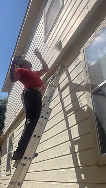 Technician cleaning a residential dryer vent in the Austin area
